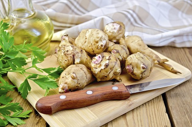 Jerusalem artichoke with a knife and oil on board