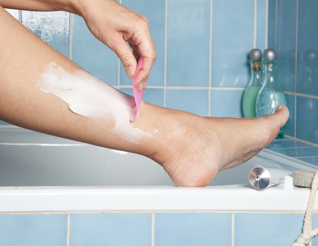 Shaving her legs