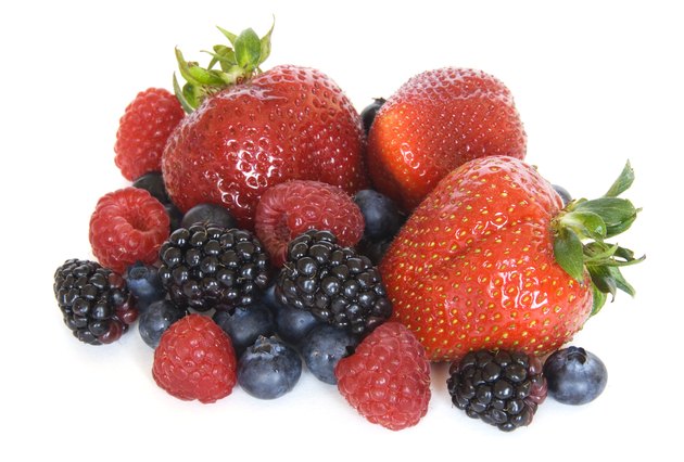 Mixed berries - strawberries, raspberries, blackberries and blueberries on white