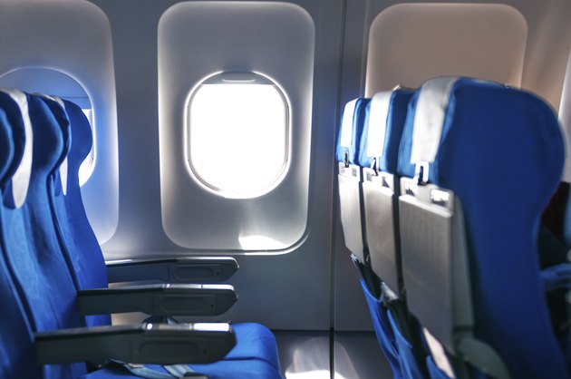 Empty aircraft seats and windows.