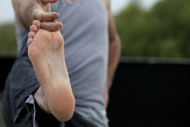 Man doing yoga hold his big toe.