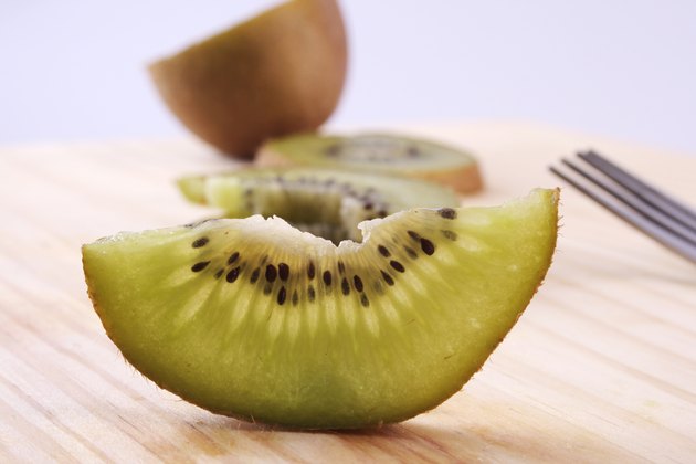 A studio shot of several slice of kiwifruit
