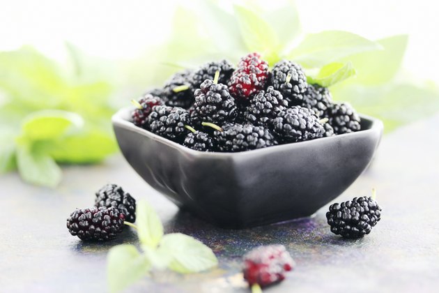 juicy mulberry on a black plate