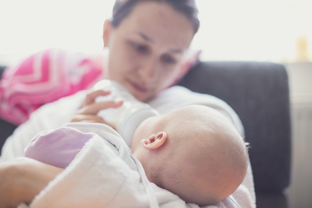 Mother feeding her newborn baby girl