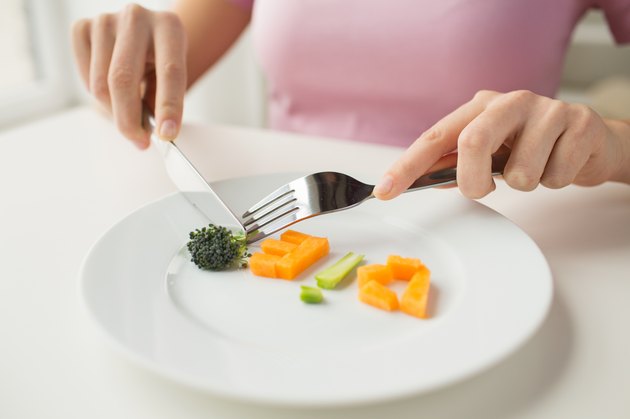 close up of woman hands eating vegetables