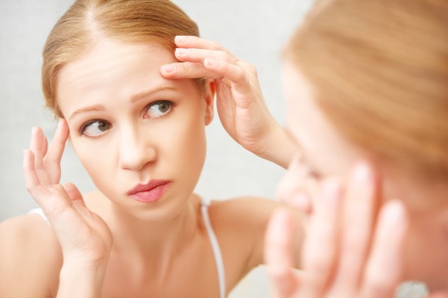 beautiful healthy woman frightened saw in the mirror acne