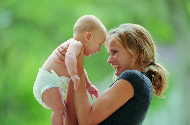 Side view of mother laughing with baby