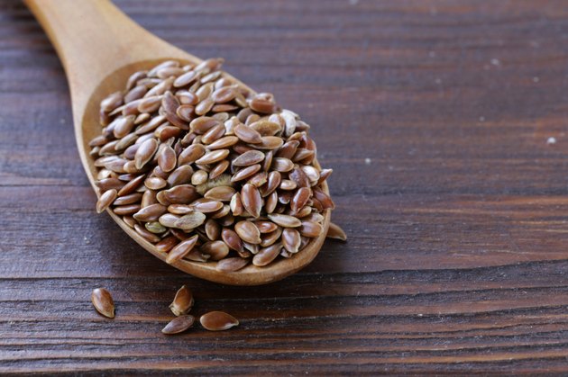 Flax seed in a wooden spoon on the table