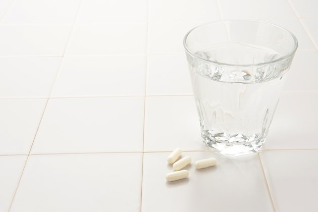 Capsule and cup of water