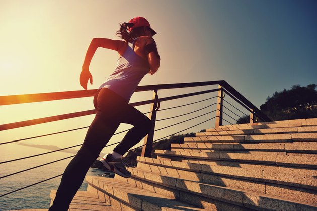 healthy lifestyle asian woman running at stairs seaside