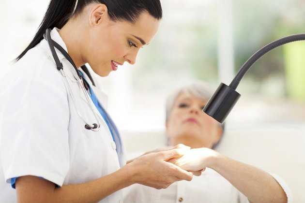 dermatologist examining senior woman's skin