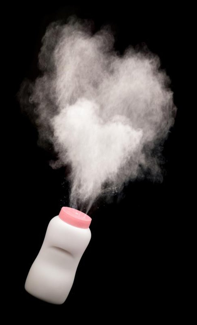 spilled baby powder on black background