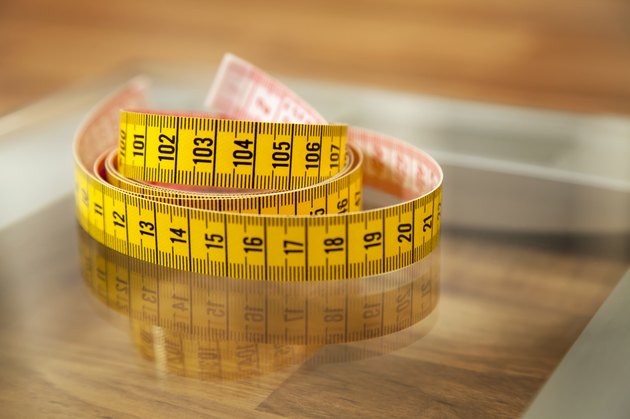 Measuring tape on weight scale.