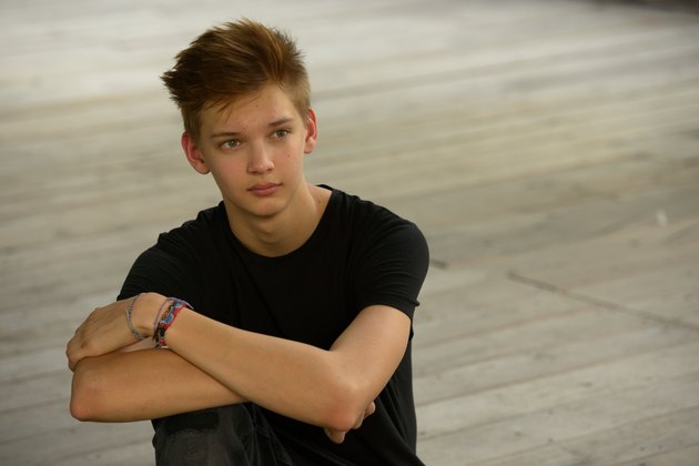 Teenager boy with hope outdoors