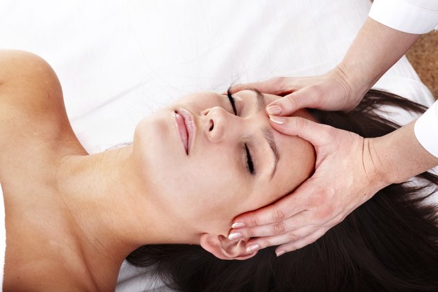 Young woman and beautician. Facial massage.