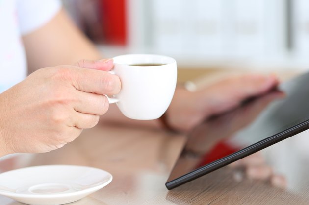 Female hands holding black tablet pc