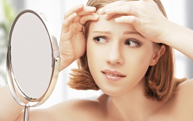 beautiful healthy woman frightened saw in the mirror acne