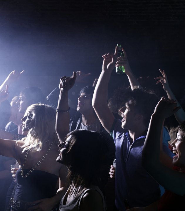 Group of friends celebrating at party in night club