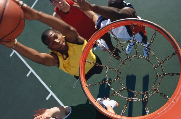 high angle view of a basketball player slam dunking a basketball