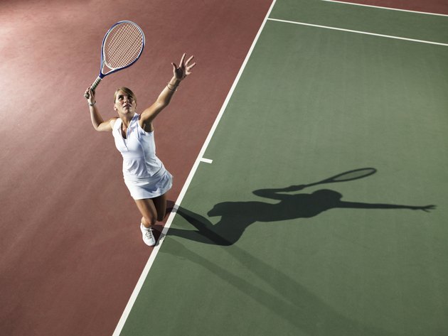 Young woman playing tennis, elevated view