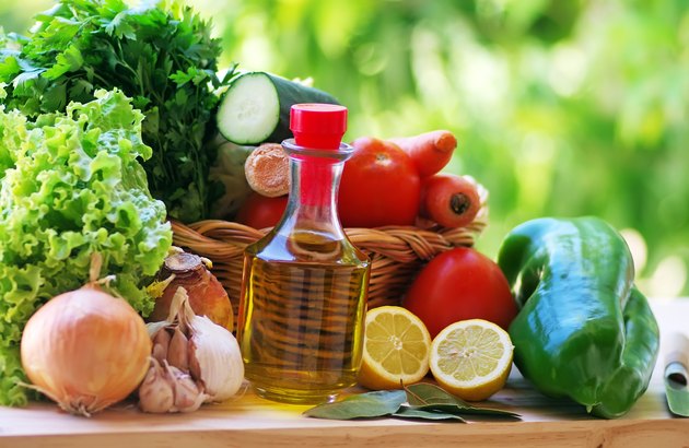 olive oil and vegetables on table