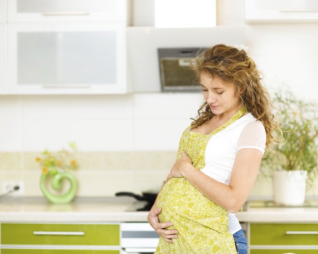 pregnant woman at home in kitchen