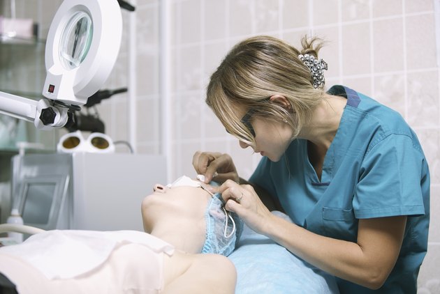 Beautician in a skin clinic with patient