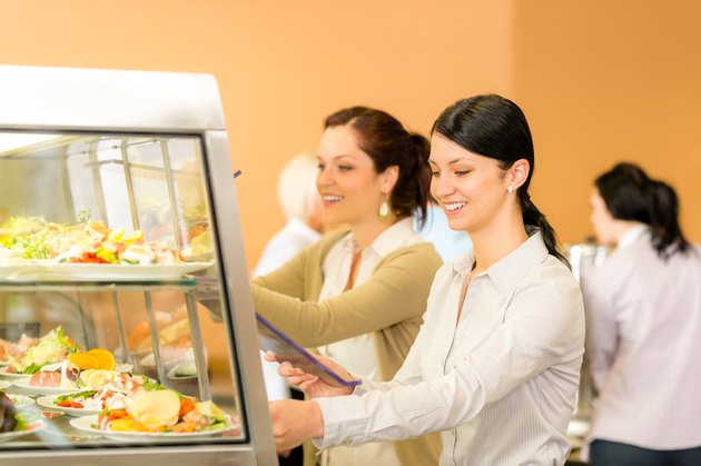 Cafeteria lunch young woman take salad plate