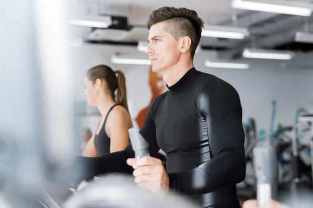 Young group of people working out on a elliptic trainer