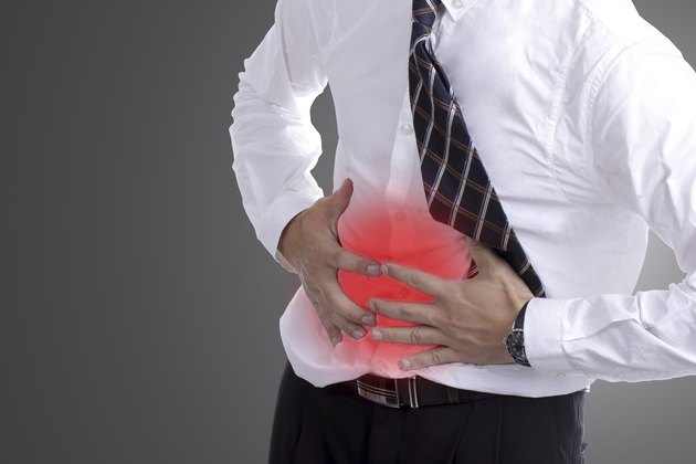 businessman holding stomach for show his stomachache