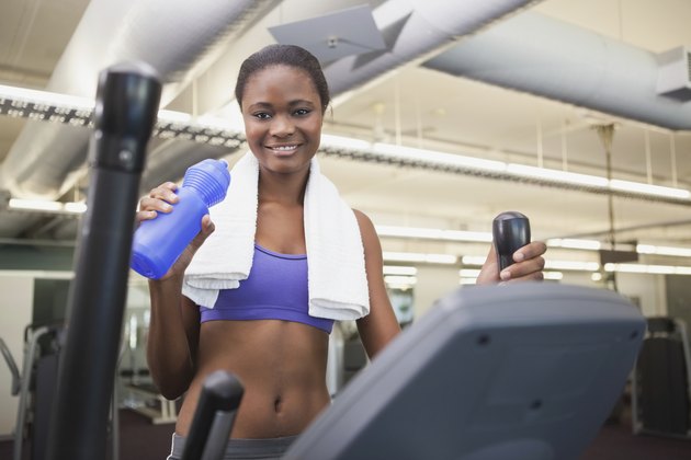 Fit woman working out on the cross trainer