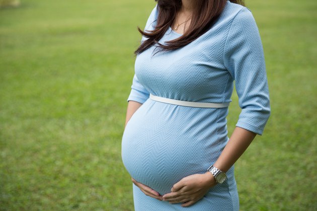 close up Asian pregnant woman hands on the belly