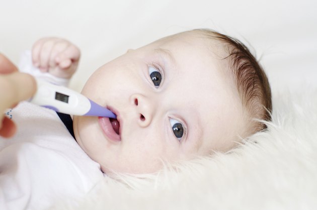 lovely baby take temperature with electronic thermometer