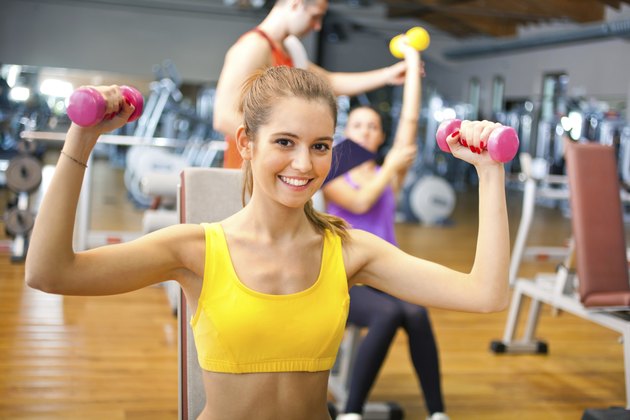Young woman lifting weights
