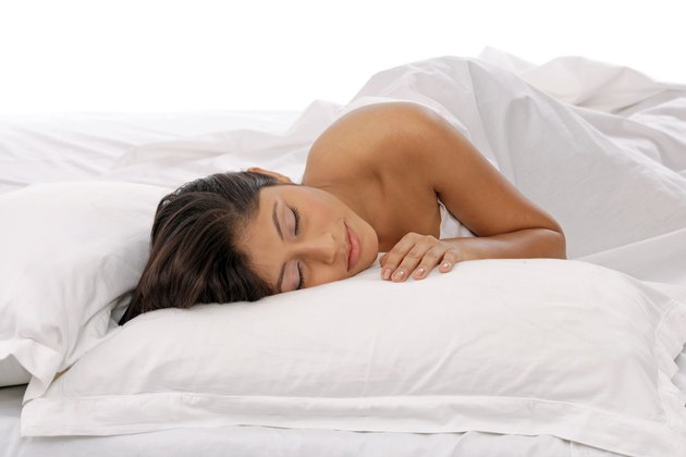 Young woman sleeping in bed