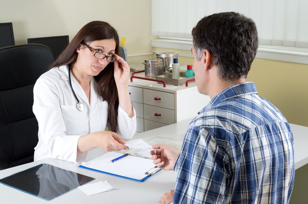Female Doctor Giving Recipe to a Patient in Doctor's Office