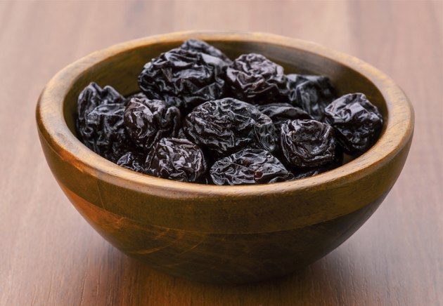 prunes group in wooden bowl