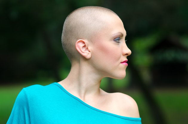 Bald cancer survivor in summer nature