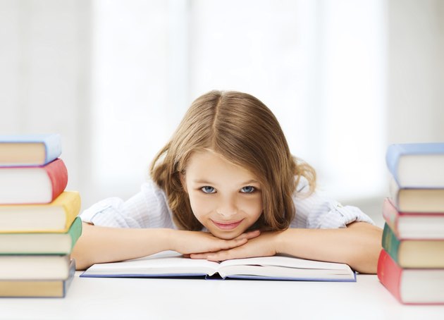 pretty girl with many books at school