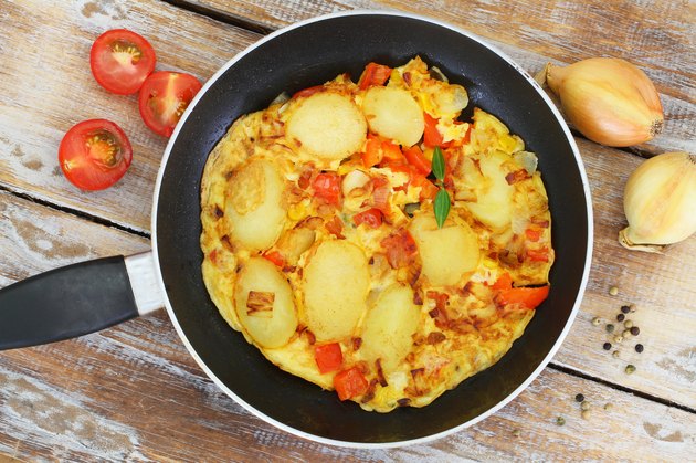 Omelette with potatoes, onions, pepper and sweetcorn in frying pan