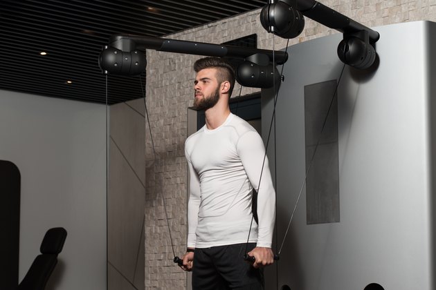 Healthy Young Man Doing Exercise For Shoulders