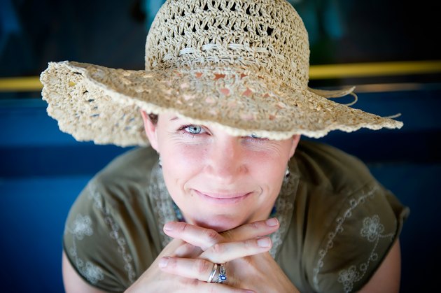 Woman with straw hat flirts