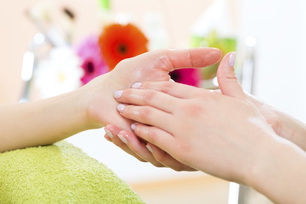 Woman in nail salon receiving hand massage