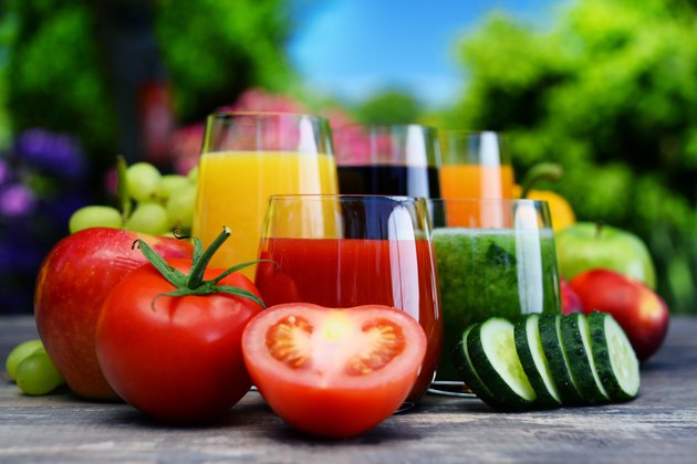 Glasses with fresh organic detox juices in the garden