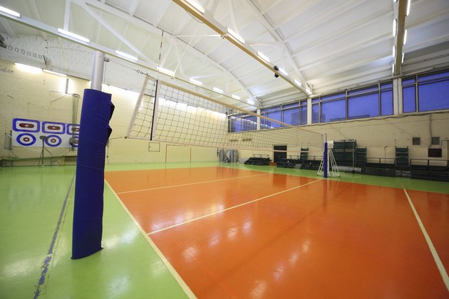Volleyball net inside lighted school gym hall