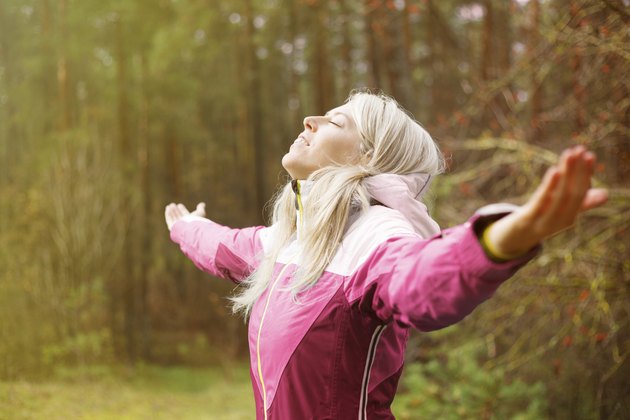 Woman breathes fresh air outdoors