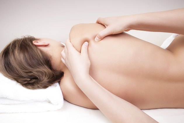 Deep tissue massage on a woman's shoulder blade