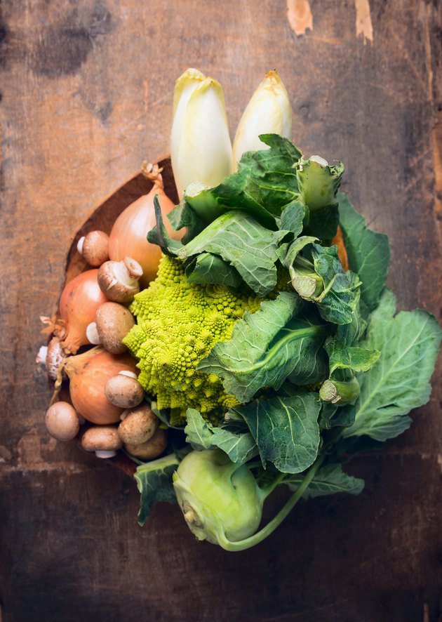 Romanesco with fresh vegetables in dish on rustic wooden background