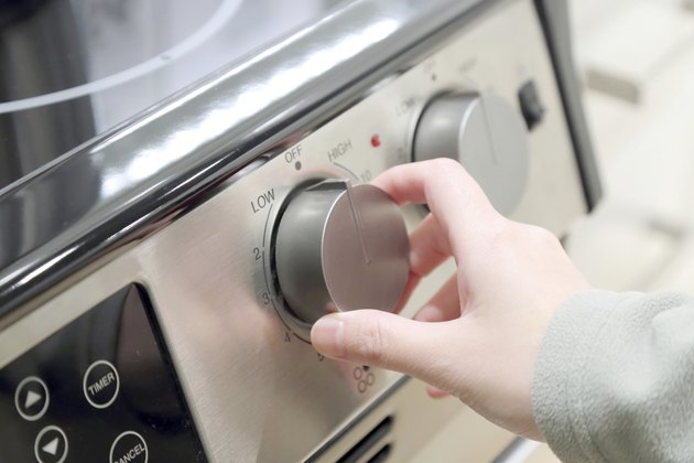 Woman turning on the oven