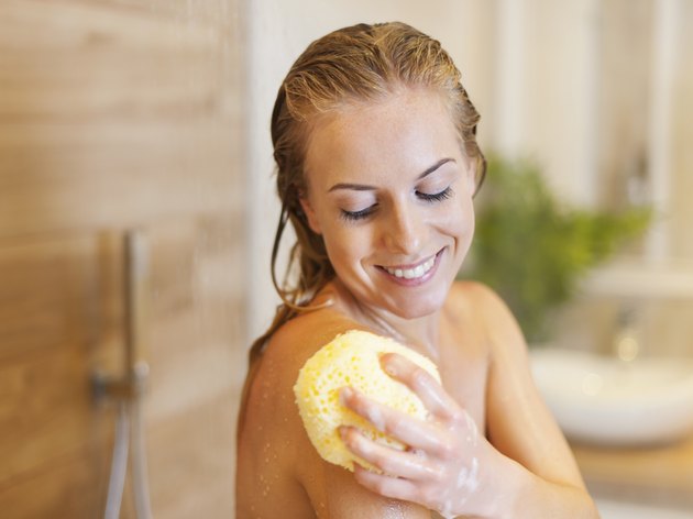 Beautiful blonde woman taking shower